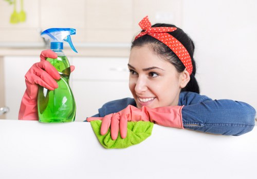 Team member using protective gloves and PPE during cleaning