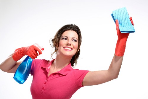 Local window cleaner working on a shopfront in Islington